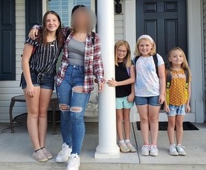 The Fritzs’ five girls pose together on the front porch.